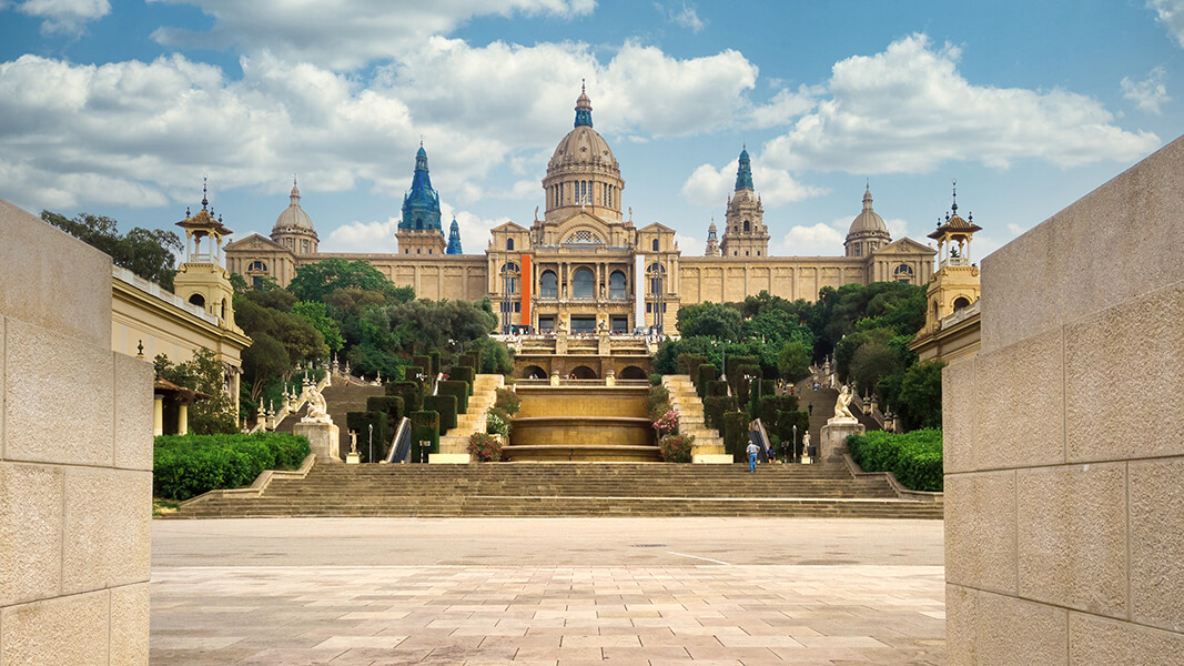 palau national barcelona spain gardens people front it cloudy sky