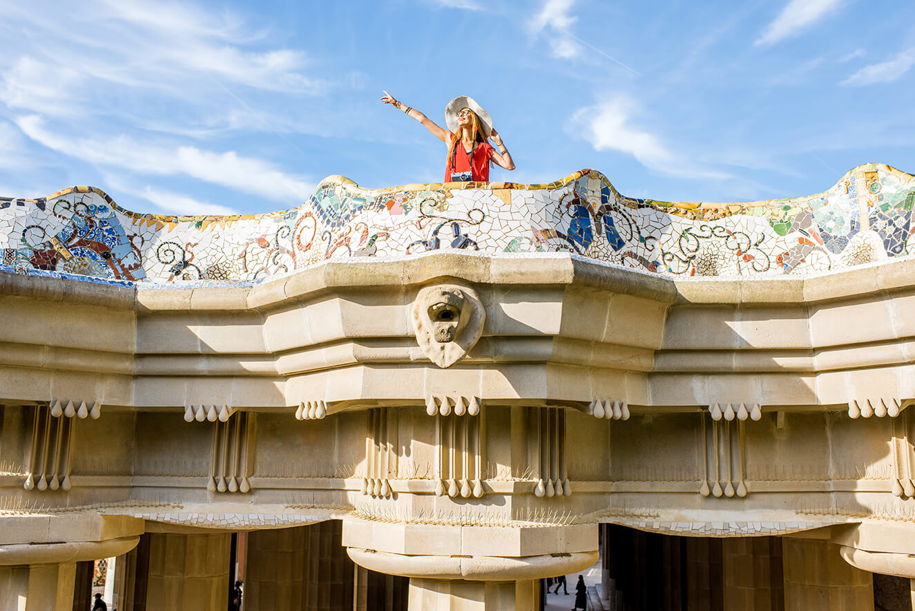 view beautiful terrace decorated with mosaic with happy woman tourist guell park barcelona